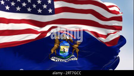 Flags of Michigan and the United States waving in the wind on a clear day. Patriotism and identity concept. 3d illustration render. Fluttering fabric. Stock Photo