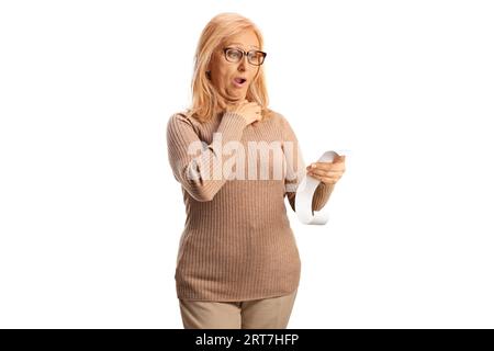 Shocked mature woman holding a bill isolated on white background Stock Photo