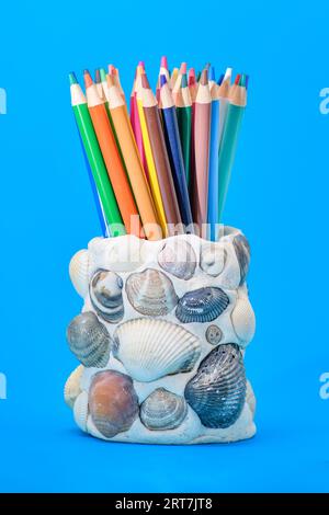 Pencil holder created with salt dough and sea shells on a blue background Stock Photo
