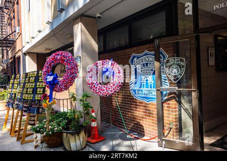 Remembrance of 9/11 at 6th precinct station with wreathes and list of police officers lost on September 11, 2001, 10th St. Greenwich Village, New York Stock Photo