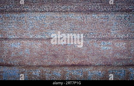 Detail of an old door with rusty iron plates and a lot of texture and contrast. Concept backgrounds and templates. Stock Photo