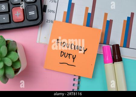 Concept of Fiduciary Duty write on sticky notes isolated on Wooden Table. Stock Photo