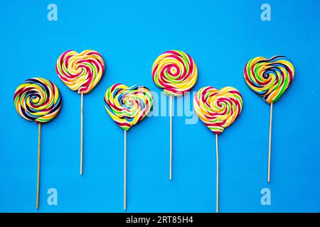 colored, different sweets, lollipops on a blue background. Copy space. Top view, sweets concept Stock Photo