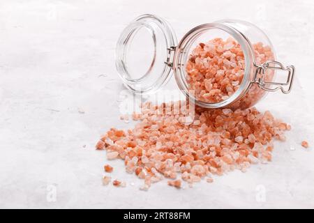 Pink himalayan salt over white stone background, close up top view with space for text Stock Photo