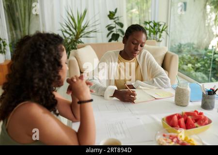Diverse college students preparing for exam at home Stock Photo