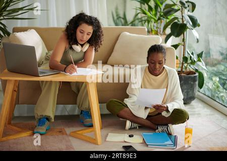Students solving math tests at home when preparing for exam Stock Photo