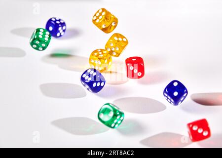 Colorful dices in motion on white background Stock Photo