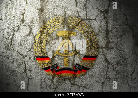 National symbol of German Democratic Republic (GDR) on a cracked wall Stock Photo