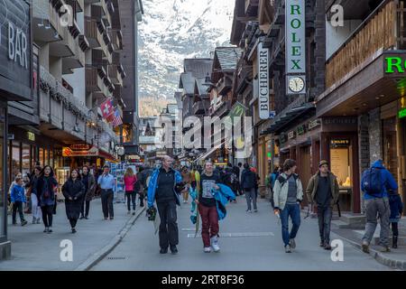Zermatt, Switzerland, April 11, 2017: People walking on the main road in the city centre Stock Photo