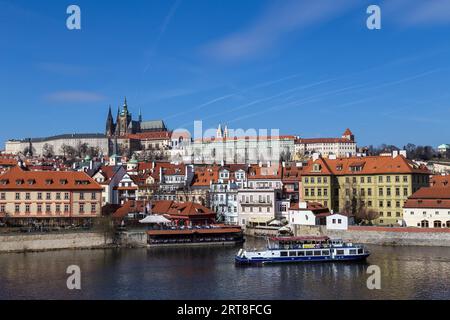 Prague, Czech Republic, March 16, 2017: Vlata River Water front with Prague Castle in the background Stock Photo