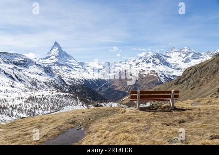 A bench with view of the Swiss Alps with the famous Matterhorn Stock ...