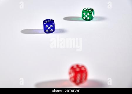 Colorful dices in motion on white background Stock Photo