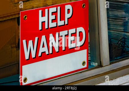 A help wanted sign stands in the window of a coffee shop, Aug. 19, 2023, in Foley, Alabama. Approximately 8.8 million job openings are unfilled. Stock Photo