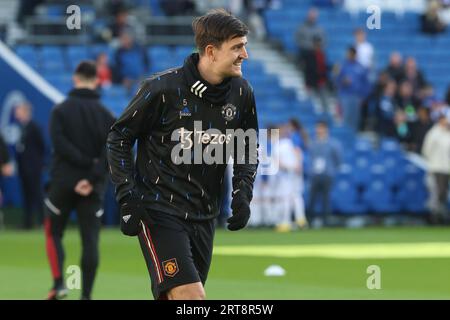 Harry Maguire warms up before kick off for Manchester United at the AMEX Stadium Stock Photo
