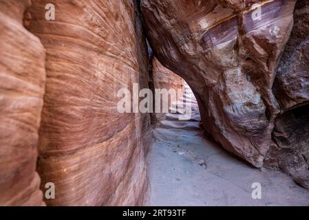 A narrow passage among rocks on the path to Monastery (Ad Deir9 building, Petra archaeological site, Jordan Stock Photo