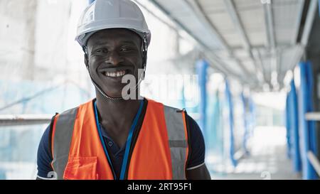 African american man builder smiling confident taking glasses off at construction place Stock Photo