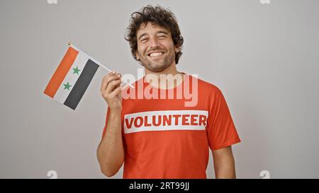 Young hispanic man activist holding syria flag over isolated white background Stock Photo