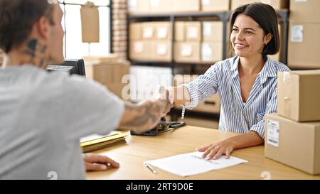 Two ecommerce business worker and client shaking hand at office Stock Photo