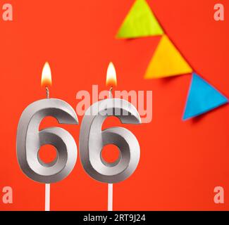 Birthday card - Number 66 candle in orange background Stock Photo