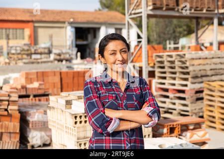 Woman worker posing at building materials warehouse Stock Photo