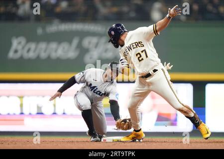 MILWAUKEE, WI - JULY 05: Milwaukee Brewers designated hitter Jesse Winker  (33) places the home run cheesehead on Milwaukee Brewers shortstop Willy  Adames (27) during a game between the Milwaukee Brewers and