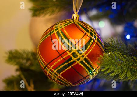 Closeup of a red  bauble hanging on a Christmas tree Stock Photo