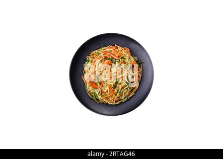 Fresh salad of sliced thin strips of carrot and zucchini on a concrete background. Vegetarian cuisine Stock Photo