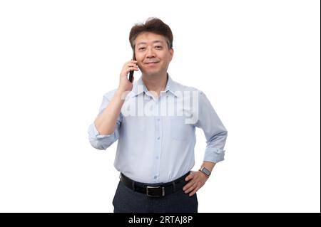 Portrait of a middle-aged Asian male businessman in his 50s wearing a blue shirt Stock Photo