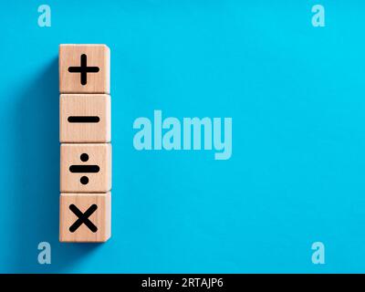 Basic mathematical operations symbols. Plus, minus, multiply and divide symbols on wooden cubes. Mathematic or math education and basic calculations f Stock Photo