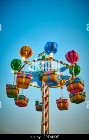 Hot air balloon vertical rounabout on fun fair Stock Photo