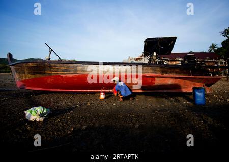 Koh Yao, Thailand; 1st January 2023: Fishermen fixing their long Tail boats in the fishing village of Koh Yao. Stock Photo