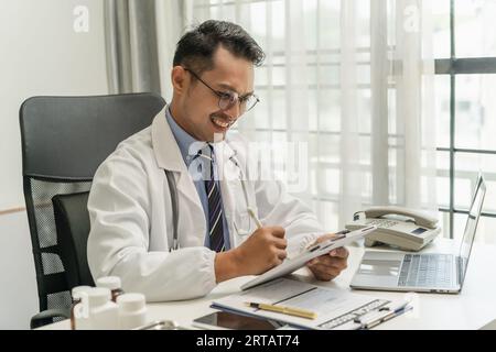 Doctor Man's professional work using a digital tablet at his hospital research medicine digital care healthcare concept Stock Photo