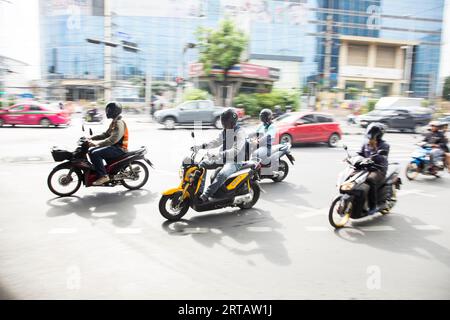 Bangkok, Thailand; 1st January 2023: Motorbikes driving through the city center of Bangkok. Stock Photo