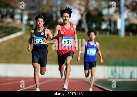 Japanese athletes running on track Stock Photo