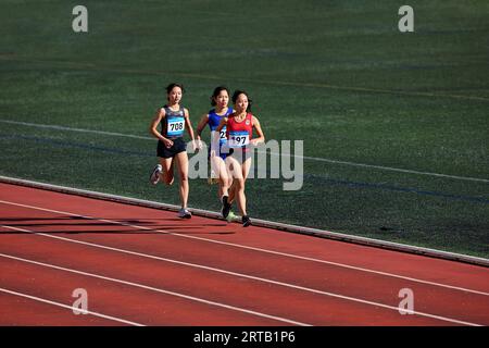 Japanese athletes running on track Stock Photo