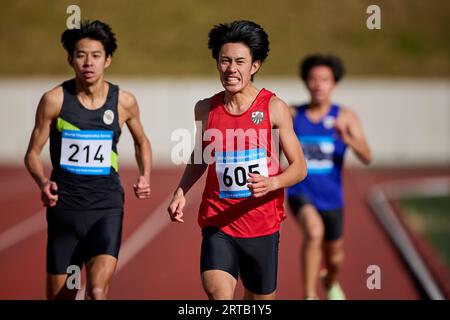 Japanese athletes running on track Stock Photo