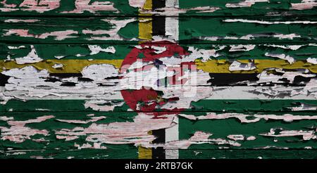 Flag of Dominica painted on a grunge wooden board. Stock Photo