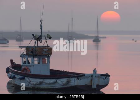 Boats on a river at sunrise Stock Photo