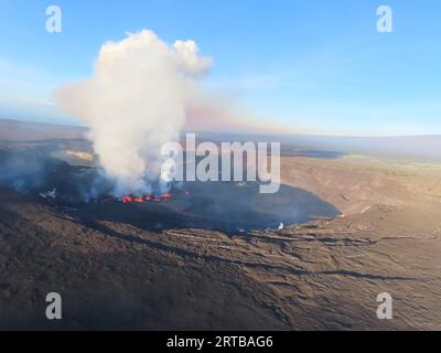 Kilauea, United States. 12th Sep, 2023. An aerial view showing steam rising from magma fountains inside the Kilauea volcano caldera as it erupts at Hawaii Volcanoes National Park, September 11, 2023 in Kilauea, Hawaii. The volcano, one of the most active on earth began erupting after a two-month-long pause. Credit: Johanne Schmith/USGS/Alamy Live News Stock Photo