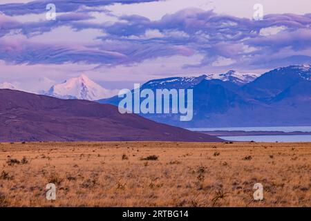 Bizarrely ruffled clouds over the snowy Andes mountains at dawn, Santa Cruz Province, Argentina, Patagonia Stock Photo