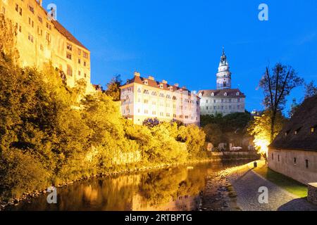 Castle and small castle with castle tower over the Vltava river in the evening light in Český Krumlov in South Bohemia in the Czech Republic Stock Photo