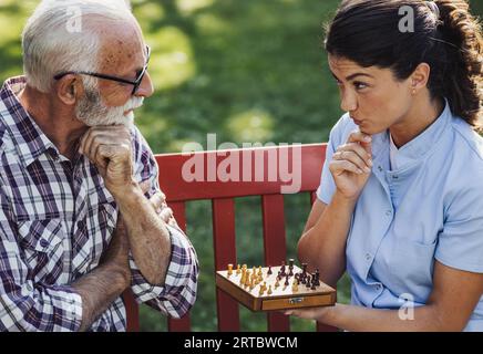 Premium Photo  Woman playing chess online on tablet computer