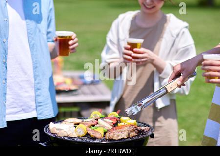 Japanese people having barbecue at city park Stock Photo