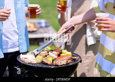 Japanese people having barbecue at city park Stock Photo