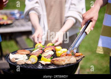 Japanese people having barbecue at city park Stock Photo