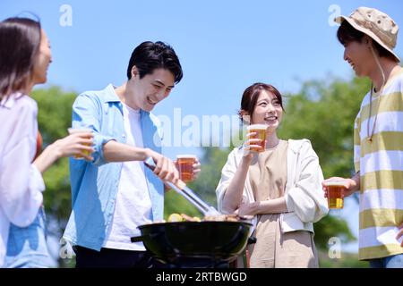 Japanese people having barbecue at city park Stock Photo