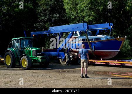 Boat being launched, by tractor, onto the River Ouse, at Acaster Maine, Acaster Malbis, North Yorkshire, England UK Stock Photo
