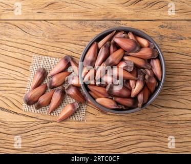 Pinions or pine tree seeds on a bowl over wooden table. Stock Photo