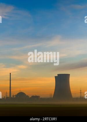 Grafenrheinfeld nuclear power plant in the fog and evening light, Schweinfurt district, Lower Franconia, Franconia Bavaria, Germany Stock Photo
