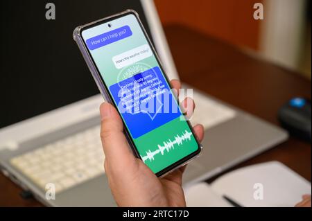 A man using AI voice services on a mobile device. artificial intelligence concept Stock Photo